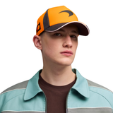 Man wearing a PUMA McLaren orange cap with dark grey accents
