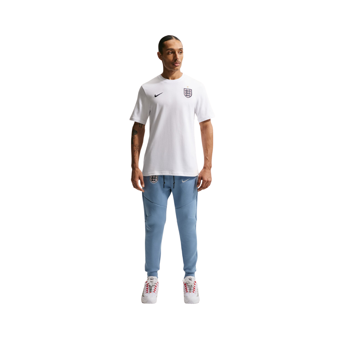 Person wearing a white Nike t-shirt and light blue jeans on a white background