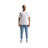 Person wearing a white Nike t-shirt and light blue jeans on a white background