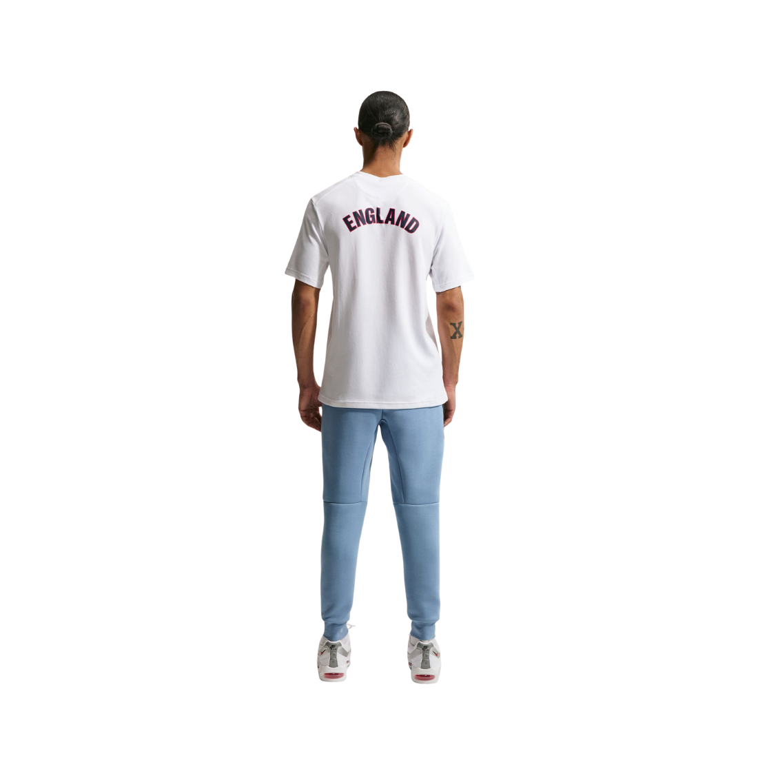 Person wearing a white t-shirt with 'ENGLAND' printed on the back, standing against a white background.