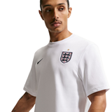 Man wearing a white t-shirt with a logo on a white background