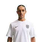 Person wearing a white sports jersey with a logo on a white background