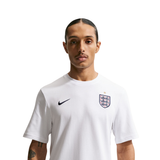 Person wearing a white sports jersey with a logo on a white background