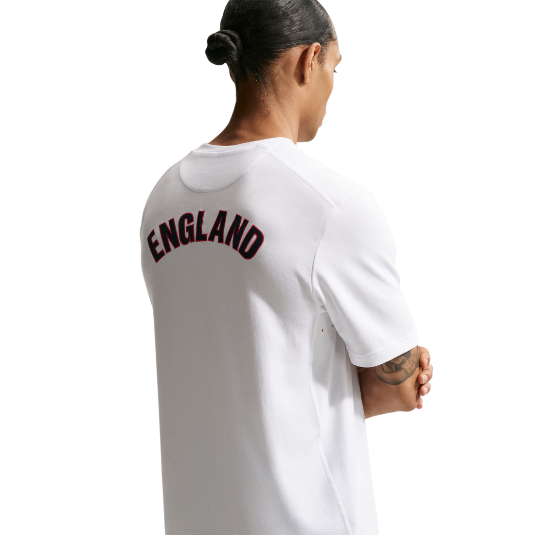 Person wearing a white t-shirt with 'ENGLAND' printed on the back, standing against a white background.