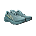 A pair of Asics running shoes in a muted teal blue-green colorway, featuring a textured knit upper, matching laces, a thick cushioned midsole, and a light yellow/green ASICS logo on the side.