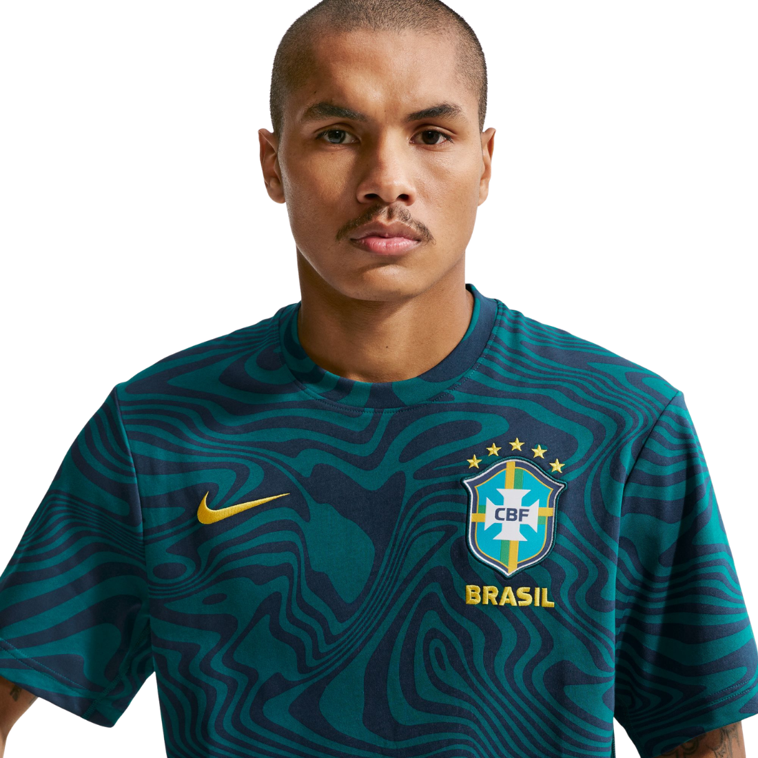 Person wearing a green soccer jersey with CBF and Nike logos on a white background