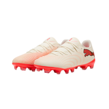 A pair of Puma soccer cleats in off-white with a subtle pink gradient pattern on the upper and bright pink/red studs and heel logo.