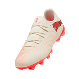 A Puma soccer cleat in off-white with vibrant pink accents, featuring a red Puma cat logo on the side and a pink outsole.