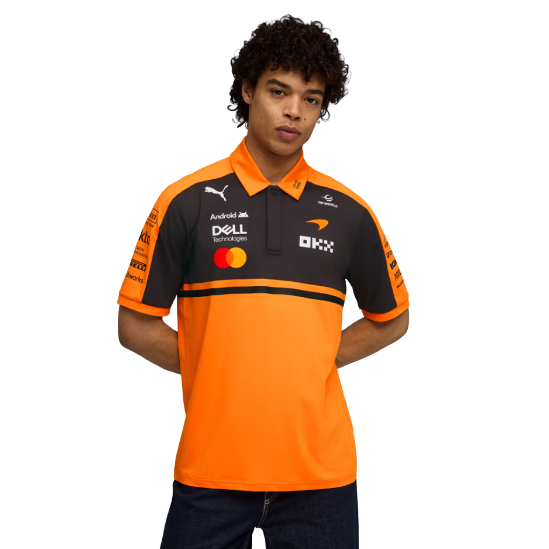Man wearing orange and black PUMA McLaren replica polo jersey with sponsor logos