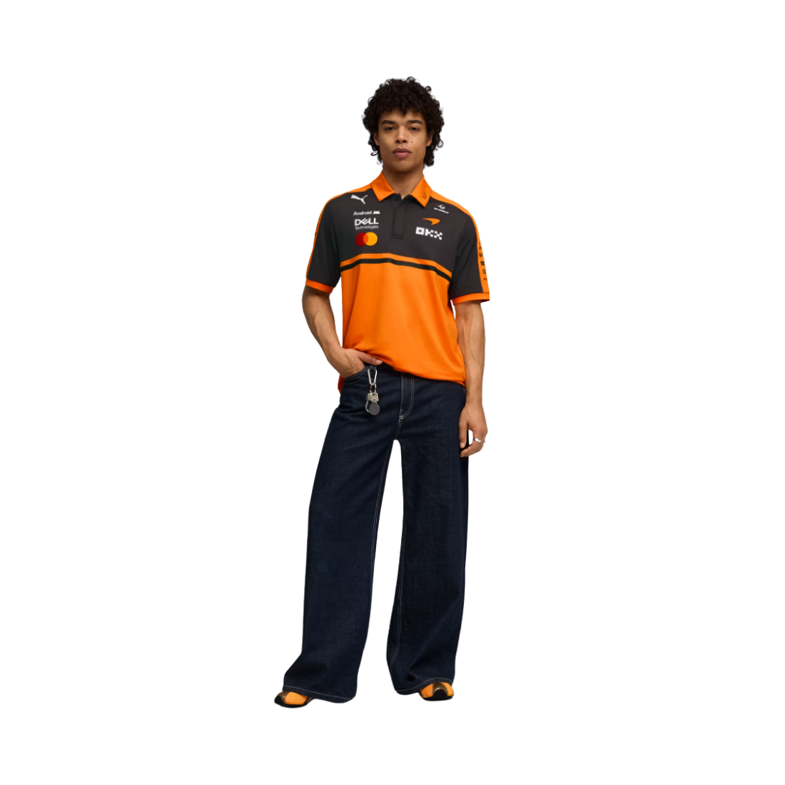 Man wearing orange and black PUMA McLaren replica polo jersey with sponsor logos