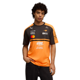 Man wearing orange and black PUMA McLaren replica jersey with sponsor logos