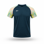 A short-sleeve athletic jersey in dark teal with a multicolor pastel abstract pattern on the sleeves, featuring a white logo on the left chest and a small red tag near the bottom hem.