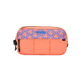 A rectangular travel pouch in bright coral orange, featuring a patterned top panel in blue and orange, with a black zipper and side strap.