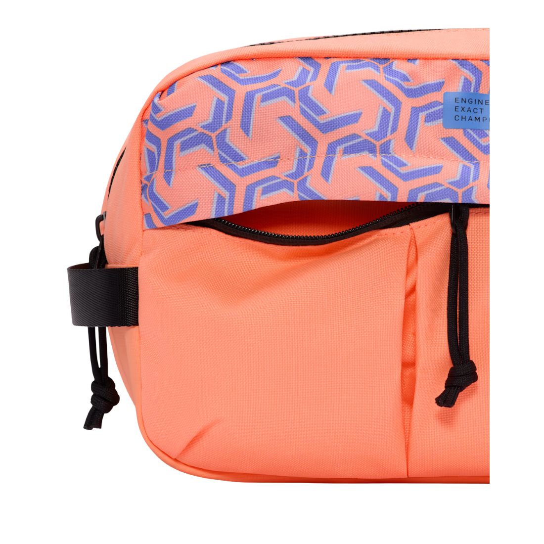 A close-up of a bright orange sling bag with a patterned top flap in blue and orange, featuring black drawstrings and a small 'ENGINE EXACT CHARGE' label.