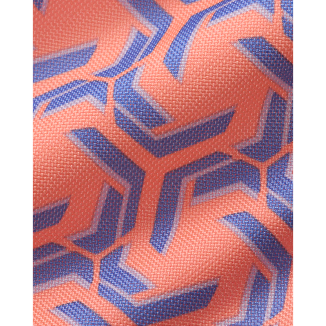 A close-up of a textured fabric with a geometric pattern in coral orange and blue.