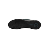 A top-down view of a black athletic shoe sole, showing the textured tread pattern and a circular logo embossed on the heel, set against a plain white background.