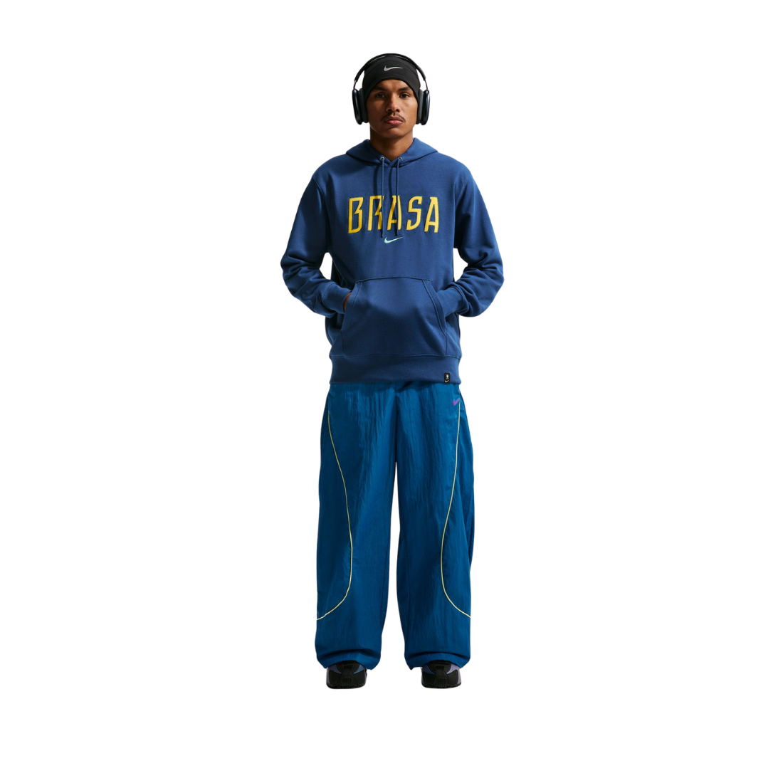 Person wearing a blue 'BRASA' hoodie and pants on a white background