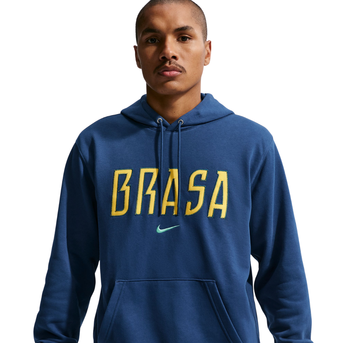 Man wearing a blue hoodie with 'BRASA' printed on it against a white background