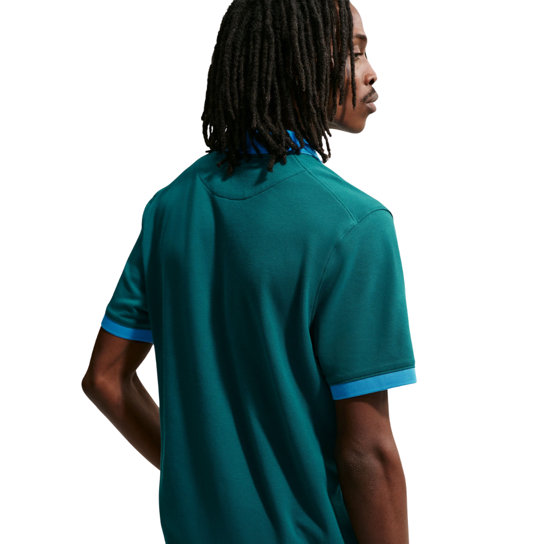 Person wearing a teal polo shirt with blue accents on a white background