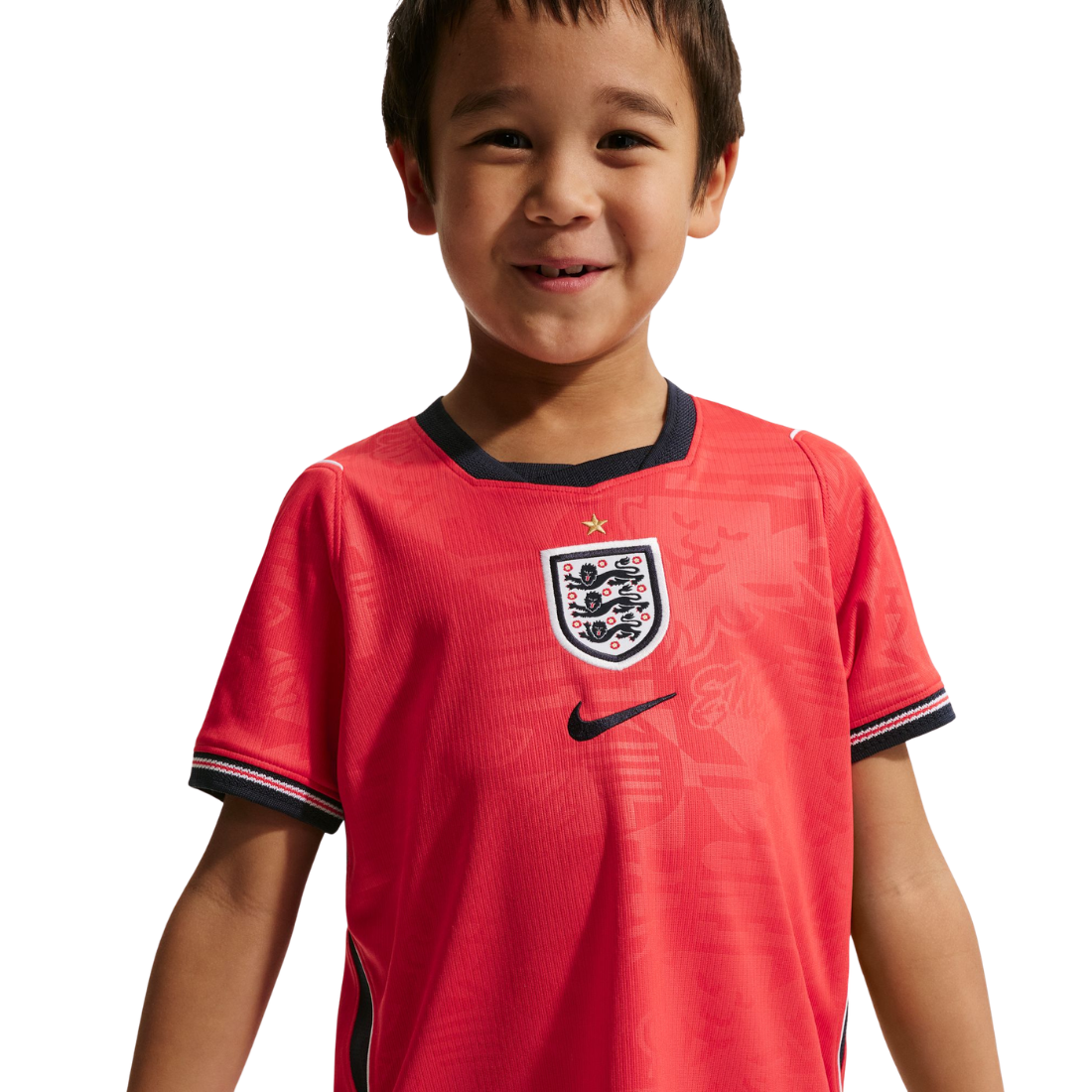 Child wearing a red England soccer jersey with Nike logo on a white background
