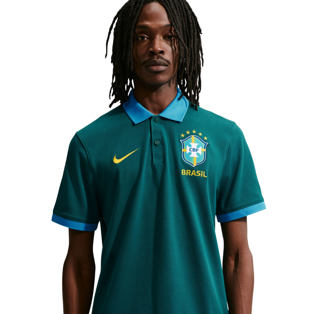 Person wearing a teal sports jersey with CBF and Brasil logos on a white background