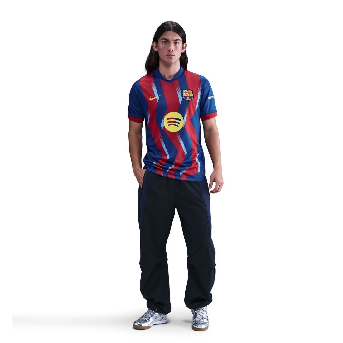 Person wearing a blue and red striped sports jersey with a logo on a white background