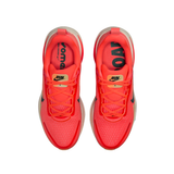 A pair of Nike running shoes in a vibrant neon orange-red colorway, shown from a top-down view on a plain white background.