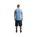 Person wearing a light blue t-shirt and navy shorts on a white background