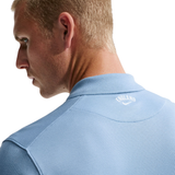 Man wearing a light blue polo shirt with 'England' branding on the collar.