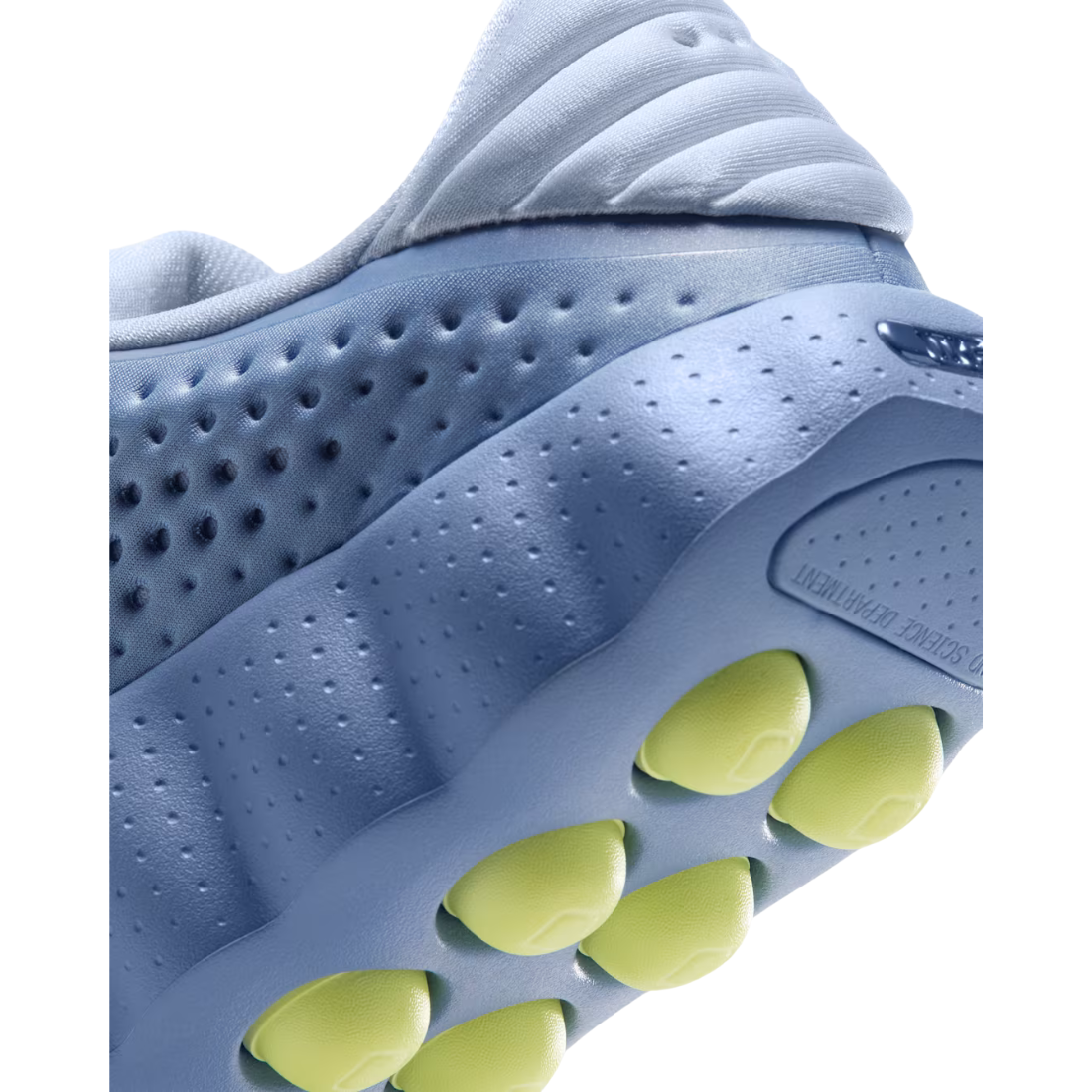 Close up of blue Nike Mind 002 training shoe heel with yellow traction pods