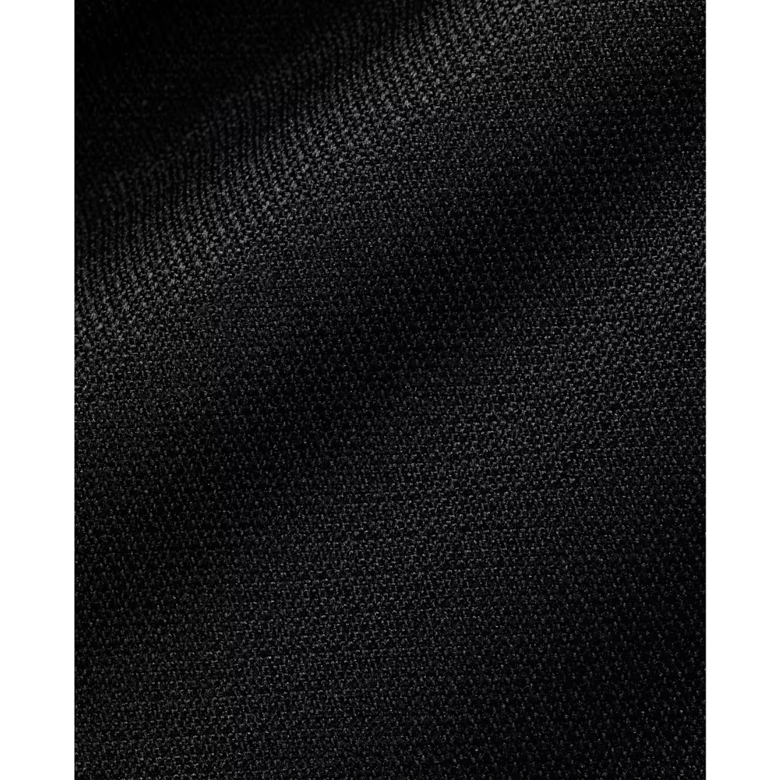 A close-up of black textured fabric with a fine woven pattern and soft folds.
