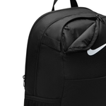Close-up of a black Nike backpack showing a zippered compartment with a white Nike swoosh logo on the front, against a plain white background.