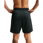 Rear view of a person wearing black athletic shorts against a plain white background.