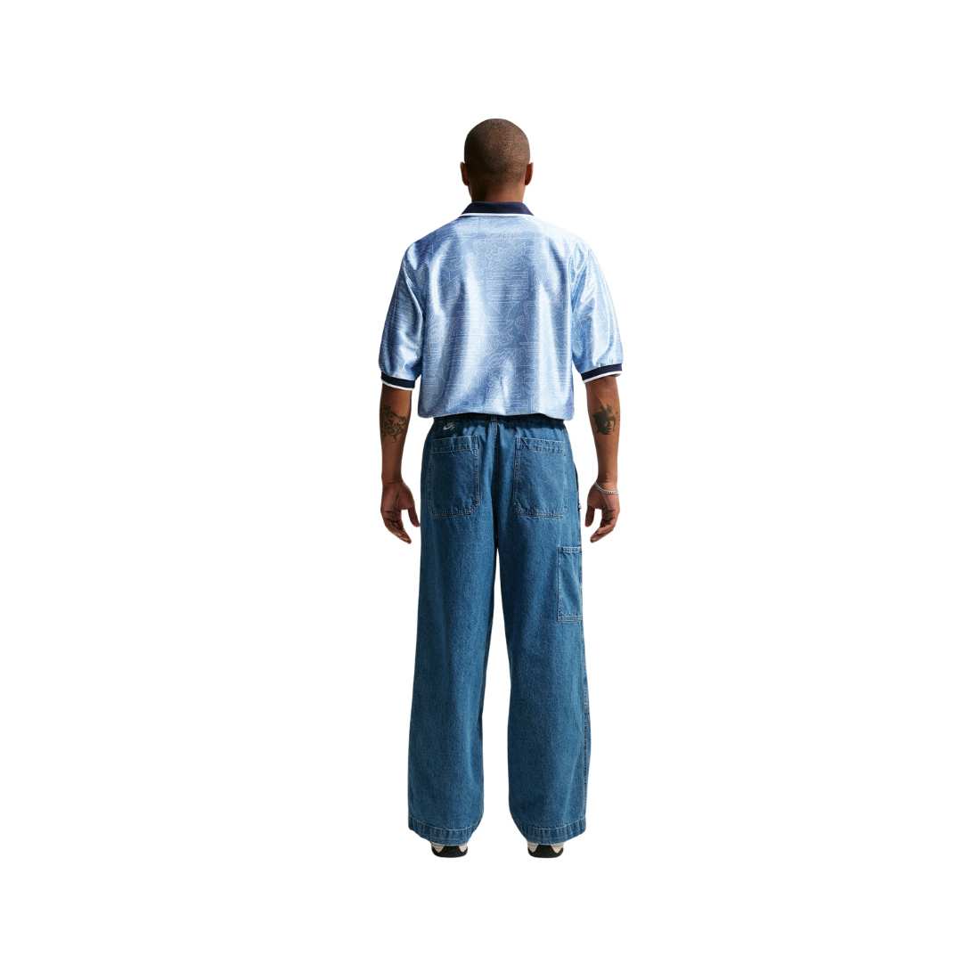Person wearing a light blue shirt and dark blue pants on a white background