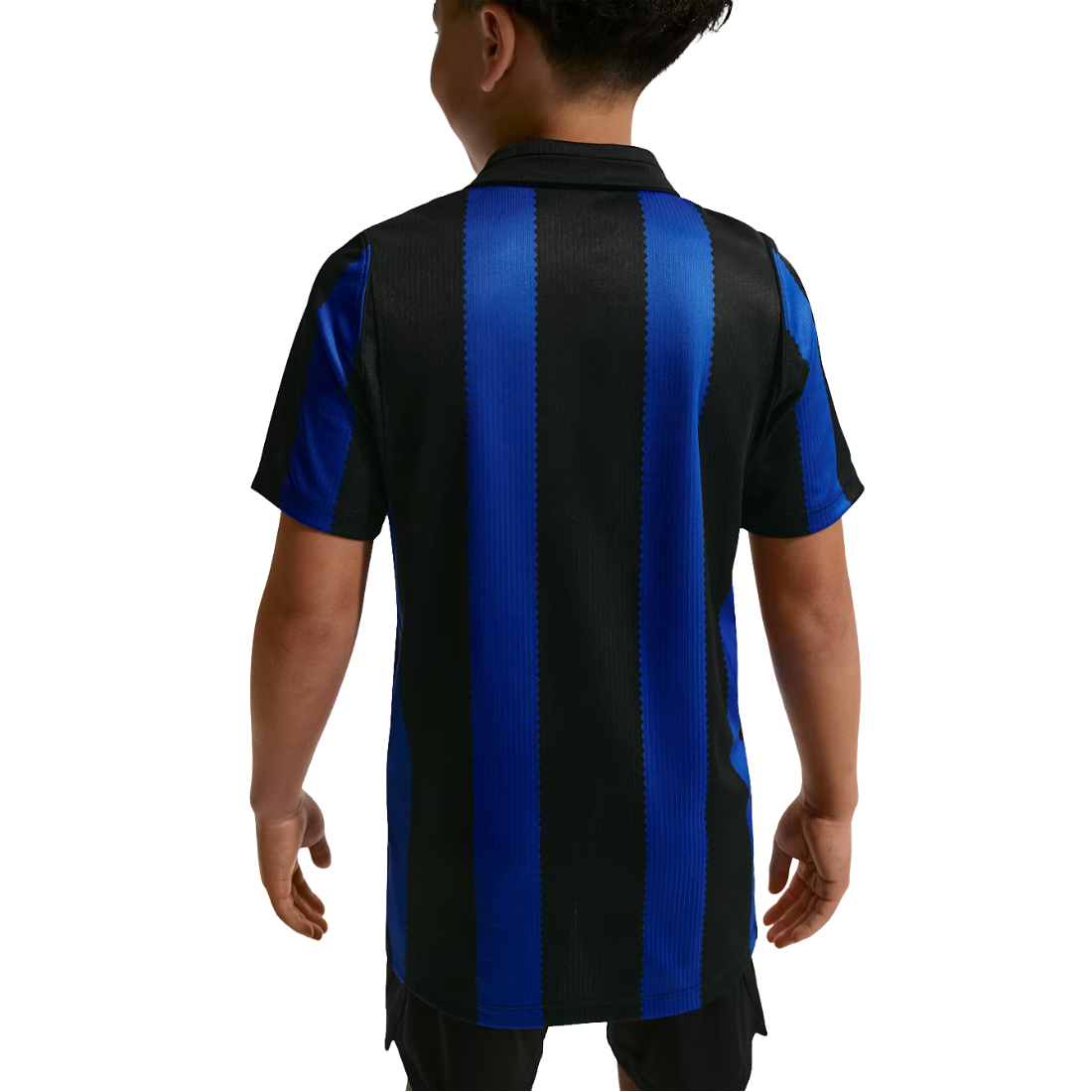 A child viewed from the back wearing a short-sleeve soccer jersey with bold vertical black and royal blue stripes.