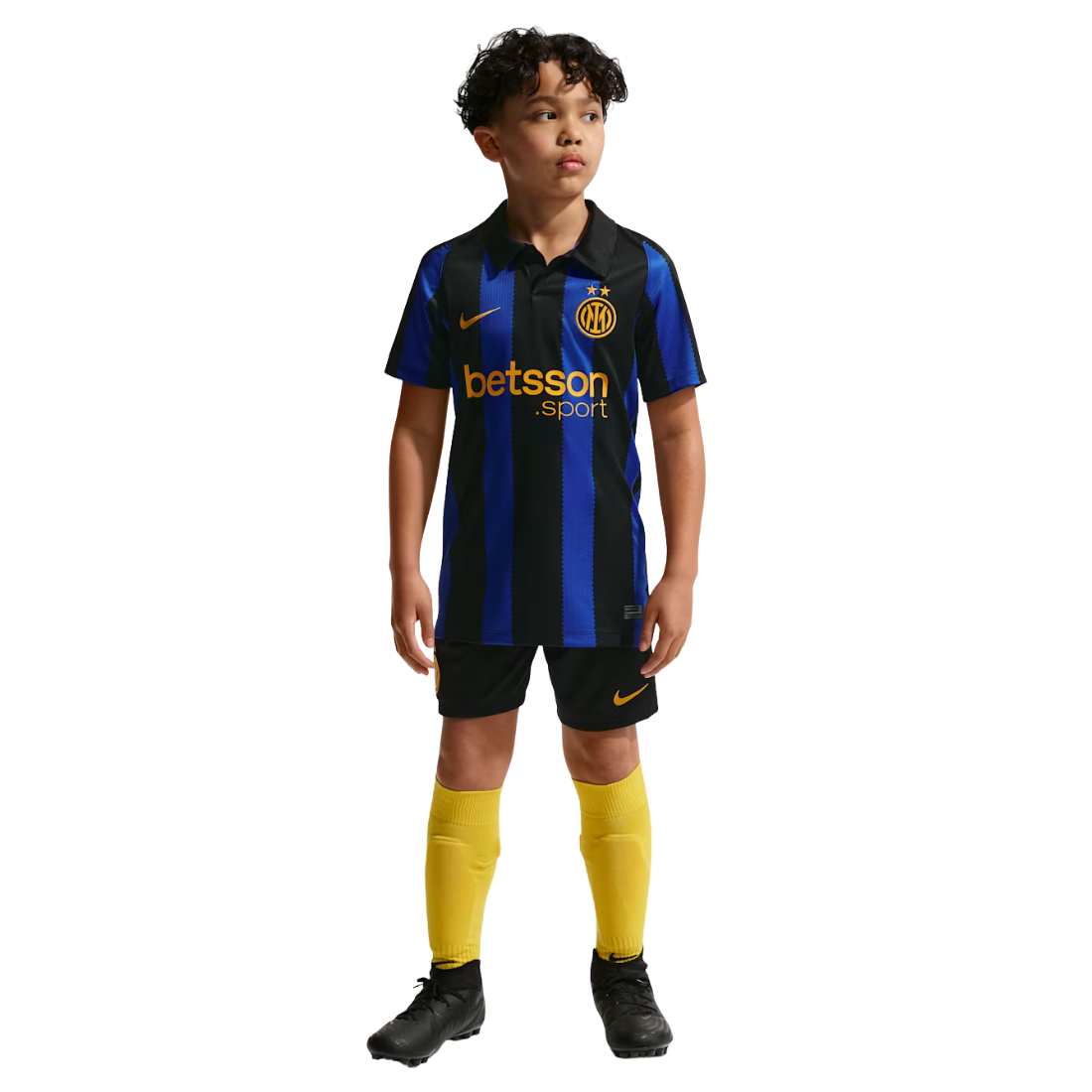 A young boy modeling a Nike Inter Milan soccer kit, featuring a blue and black vertically striped jersey with yellow accents, black shorts, and yellow socks, set against a plain white background.