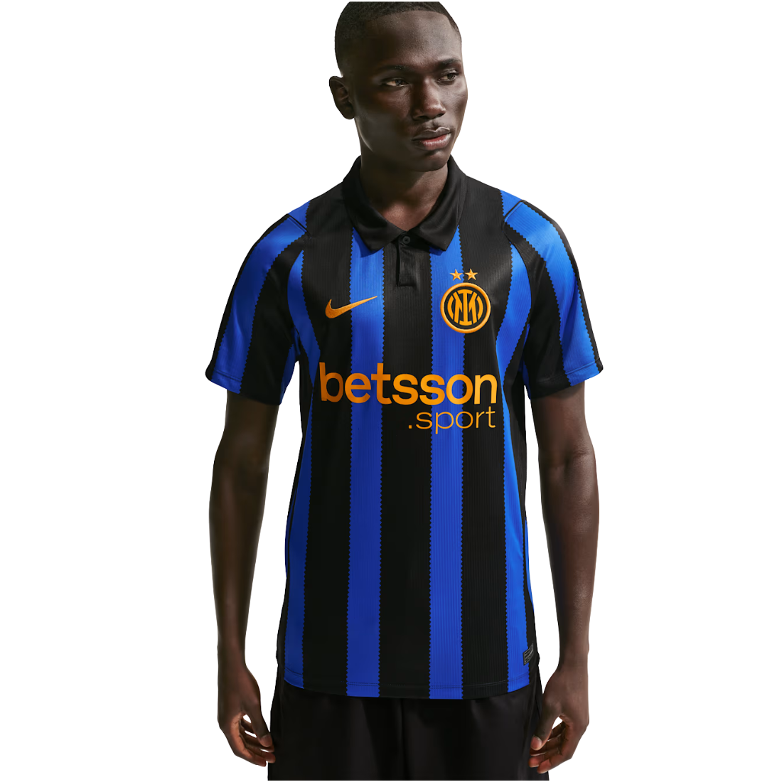 A man wearing a black and blue vertically striped Inter Milan soccer jersey with a Nike swoosh, Inter Milan crest, and Betsson sponsor logo, set against a plain white background.