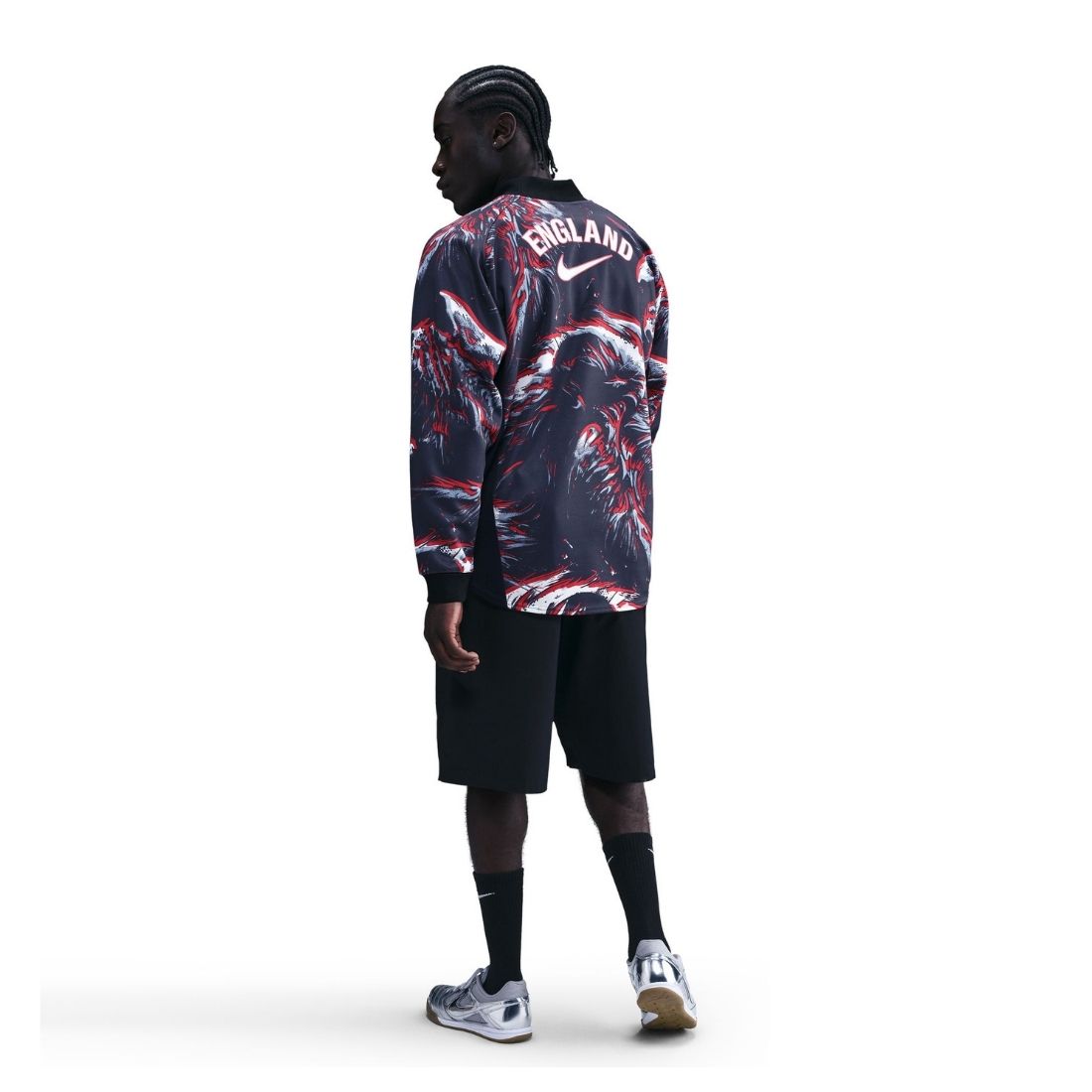 Person wearing a colorful England jacket on a white background