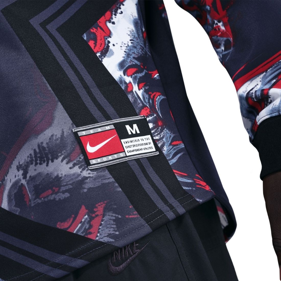 Close-up of a Nike jacket with a brand label on a white background