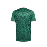Green short-sleeve athletic t-shirt with a large black Aztec calendar pattern on the back and red trim on the collar and sleeve cuffs, shown against a plain white background.