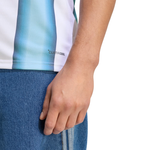 Close-up of a person wearing a striped shirt with 'Clinique' branding and blue jeans.