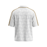 White short-sleeve athletic jersey shown from the back, featuring a subtle geometric pattern and gold braided stripes running down the shoulders and sleeves.