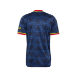 A short-sleeve soccer jersey shown from the back, featuring a dark blue and black geometric chevron pattern with red and yellow trim on the collar and sleeve cuffs. The brand logo on the right sleeve is partially visible as 'el.