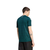 A man shown from the back wearing a dark teal short-sleeve athletic jersey with a subtle tonal pattern and white stripes on the shoulders, paired with black shorts, against a plain white background.