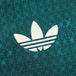 A close-up of a white Adidas trefoil logo on a textured teal and dark green fabric background.