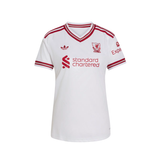 White short-sleeve V-neck soccer jersey with red stripes on the shoulders and sleeves, featuring the Adidas logo, Liverpool FC crest, and red 'standard chartered' sponsor text on the chest.