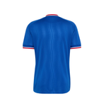 A blue short-sleeve athletic jersey shown from the back, featuring a subtle vertical wavy texture and red and white trim at the collar and sleeve cuffs, set against a plain white background.