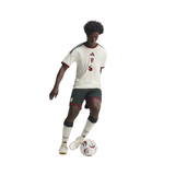 A full-body soccer player wearing an Adidas jersey, shorts, and socks, posed with a soccer ball against a plain white background.