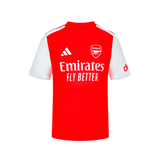A red and white short-sleeve Arsenal football jersey Junior by Adidas, featuring the Emirates Fly Better sponsor logo on the front, the Arsenal club crest, and a white adidas logo on the chest.